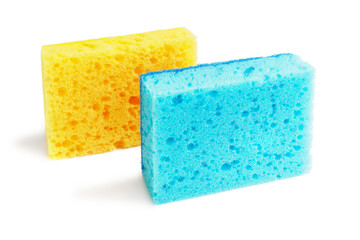 Colored sponges for washing dishes and other domestic needs. The blue sponge is on the edge in front of the yellow sponge at a slight angle. Isolate