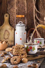 Cup of tea with a splash and biscuits with nuts