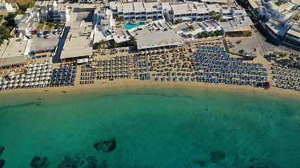 Aerial drone photo of paradise celebrity bay of Ornos famous for pool resorts and sandy turquoise organised clear sea beach, Mykonos island, Cyclades, Greece