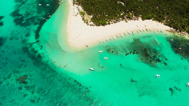 Tropical landscape: Daco island with beautiful beach, palm trees by turquoise water view from above. Siargao, Philippines. Summer and travel vacation concept