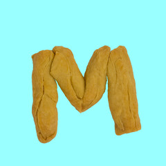 The letter M made from pastry, which can be eaten.