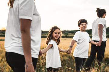 Family holding hands in the countryside happy