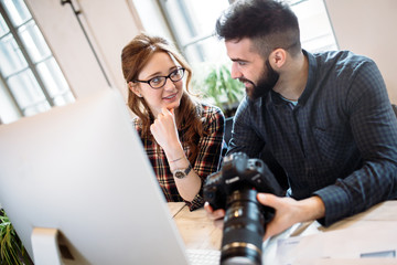 Two young designers working in modern office