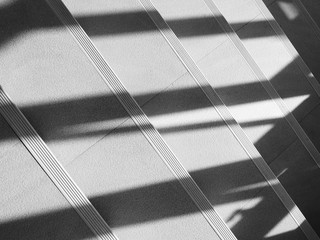 Abstract background of shadows from the window at the staircase. - monochrome