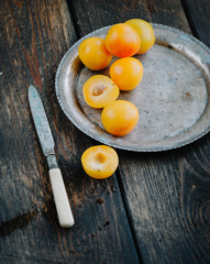 Yellow mirabelle plums in rustic metal dish