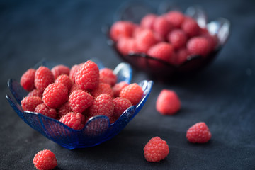 Ripe raspberries   Portion in a blue cup.