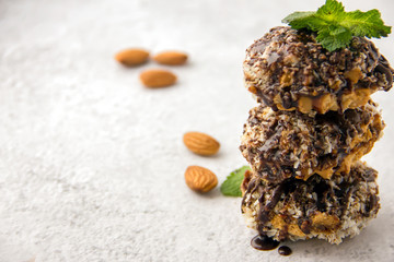 Useful homemade almond cake with coconut chips on a light background, copy space