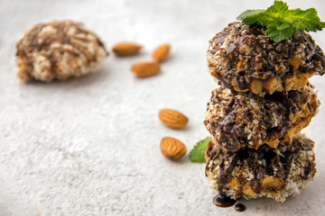 Useful homemade almond cake with coconut chips on a light background, copy space