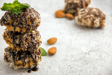 Useful homemade almond cake with coconut chips on a light background, copy space