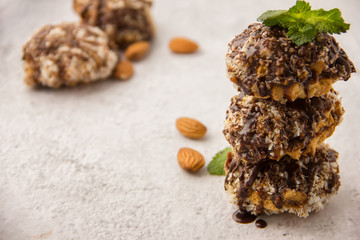 Useful homemade almond cake with coconut chips on a light background, copy space