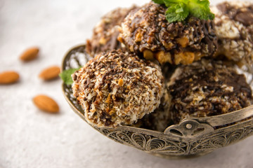 Useful homemade almond cake with coconut chips on a light background, copy space