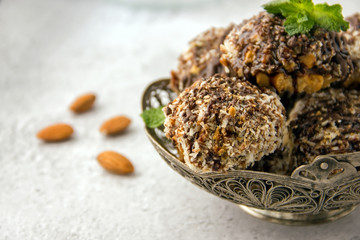 Useful homemade almond cake with coconut chips on a light background, copy space