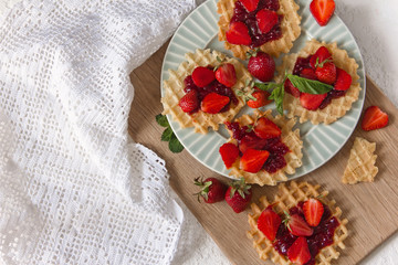 Viennese waffles with strawberries on a gray background. food photography . Flat gasket. Flatley