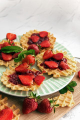 Viennese waffles with strawberries on a gray background. food photography