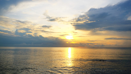 Sunrise on pastel color cloud sky at the sea in the morning on rain season.