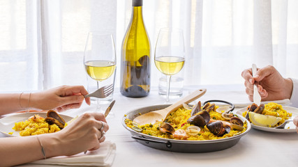 Couple  eating seafood paella in restaurant in Valencia, Spain. Typical Spanish dish lifestyle image.