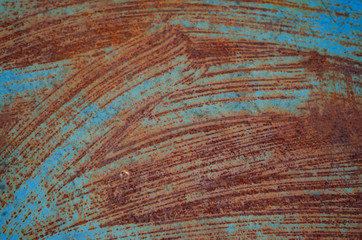The texture of the rust. Unusual background for design. Orange combined with blue.