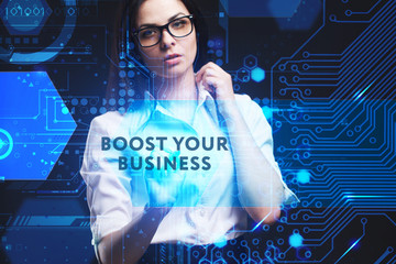The concept of business, technology, the Internet and the network. A young entrepreneur working on a virtual screen of the future and sees the inscription: Boost your business