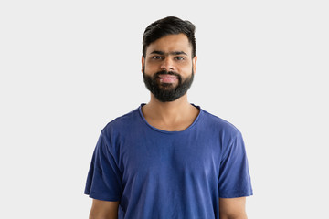 Beautiful male half-length portrait isolated on white studio background. Young emotional hindu man...