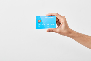 Credit card in hand on white