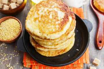 Millet pancakes in a frying pan
