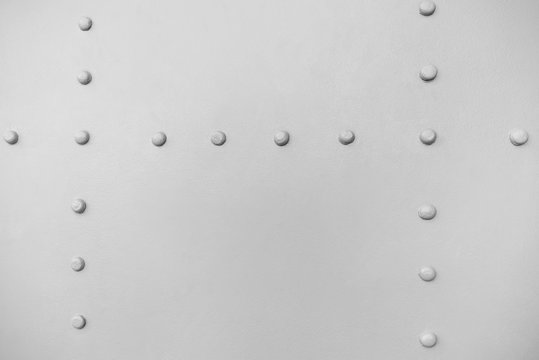 new painted gray matt chrome metal rivets on iron sheet, abstract pattern background, stock photo image with copy space for text