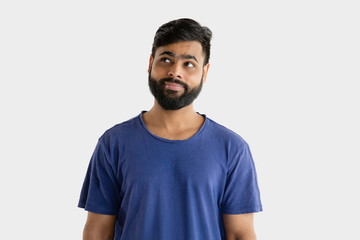 Beautiful male half-length portrait isolated on white studio background. Young emotional hindu man...