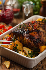 Roasted whole shoulder, with potatoes, peppers and tomatoes. Marinated in white wine.