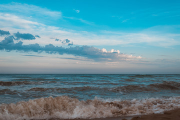 Sea with small waves and a beautiful sky in the evening.