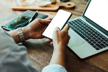 Newsletter concept hand of asian man checking message box on digital mobile phone and laptop mock up blank copy white space for your text .