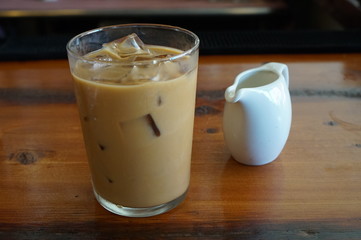Glass of Iced Coffee with Milk on a Restaurant Bar