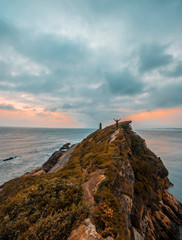 Obraz premium A young man on the top of a mountain. Photo lifestyle in a sunrise