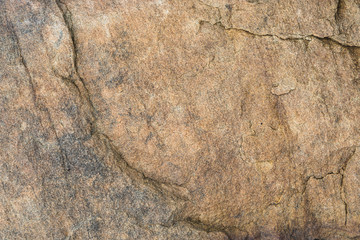 The surface of the river rocks with cracks