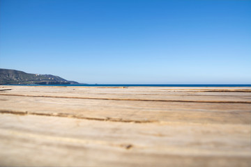 horizon between the wooden avenue leading to the beach and the blue sky