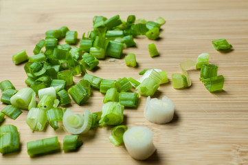 Choped chive on a wooden cutting board, close up or macro photography