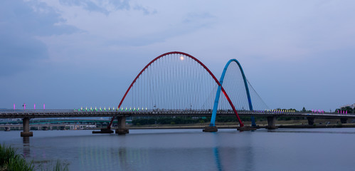 Fototapeta na wymiar The Expo Bridge and the moon with colorful reflections in Daejeon, South Korea