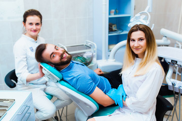 Dental clinic. Portrait of a professional dentist on the background of a working team of doctors....