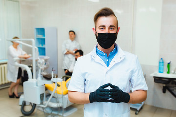 Dental clinic. Portrait of a professional dentist on the background of a working team of doctors....