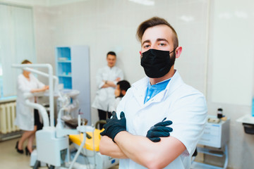 Dental clinic. Portrait of a professional dentist on the background of a working team of doctors....