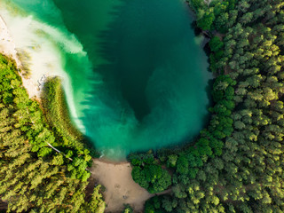 Aerial top down view of beautiful green waters of lake Gela. Birds eye view of scenic emerald lake...