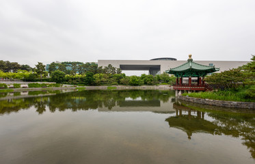 The National Museum of Korea with a pond and traditional pavilion in front, Seoul, South Korea.