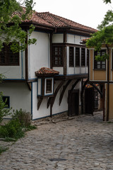 Fototapeta na wymiar View of a narrow street in historical part of Plovdiv Old Town. Typical medieval colorful buildings. Bulgaria