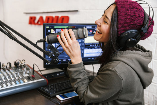 Cheerful young woman radio host broadcasting