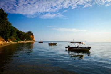 Beautiful sunrise with fisherman boats on the water