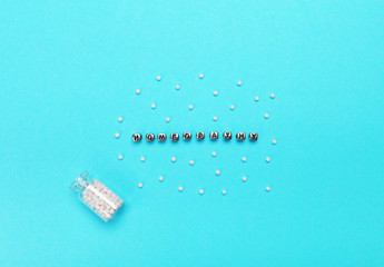 Homeopathic pills on blue background. Alternative medicine