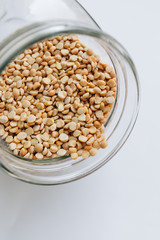 Glass jar with raw dry peas, macro