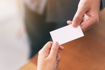Two businessman holding and exchanging empty business card