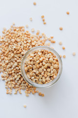 Glass jar with raw dry peas, macro