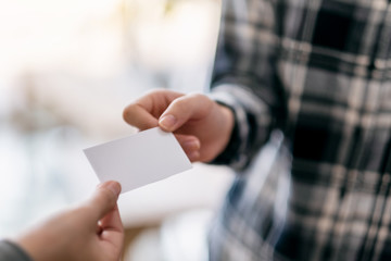 Two businessman holding and exchanging empty business card