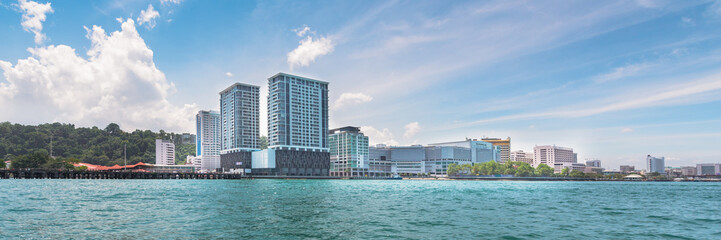 View of the city of Kota Kinabalu, Malaysia from the pier of the sea port of Geselton Point Jetty.